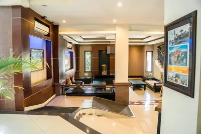 a lobby of a hotel with a staircase at Hotel Puri Ayu in Denpasar