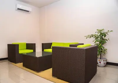 a waiting room with two chairs and a table at Hotel Puri Ayu in Denpasar