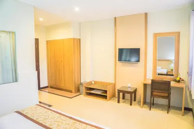 a room with a television and a desk and a chair at Hotel Puri Ayu in Denpasar