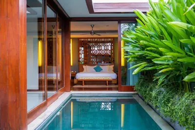 a villa with a pool in the middle of a house at Maca Villas & Spa Bali in Seminyak