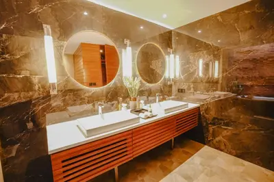 a bathroom with two sinks and a large mirror at Maca Villas & Spa Bali in Seminyak