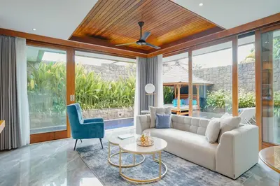 a living room with a couch and a table at Maca Villas & Spa Bali in Seminyak