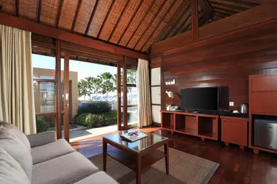 a living room with a couch and a tv at Amadea Resort & Villas Seminyak Bali in Seminyak
