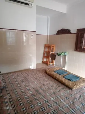 a room with a bed in the middle of a room at Cempaka 2 Homestay in Legian