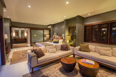 a living room with two couches and a table at Chimera Villas in Seminyak
