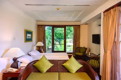 a hotel room with a bed and a window at The Patra Bali Resort & Villas - CHSE Certified in Kuta