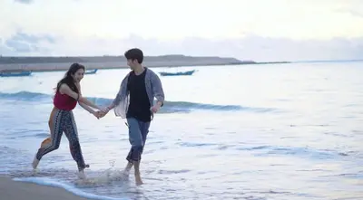 a man and a woman walking on the beach at The Patra Bali Resort & Villas - CHSE Certified in Kuta