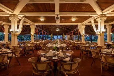 a restaurant with tables and chairs in a room at Bali Tropic Resort & Spa - CHSE Certified in Nusa Dua
