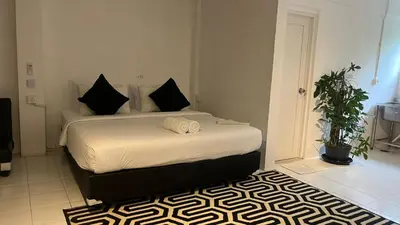 a bedroom with a large bed in a room at Kampoeng Saya in Seminyak