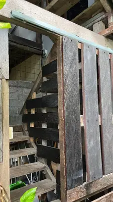 a set of wooden stairs in a building at Kampoeng Saya in Seminyak