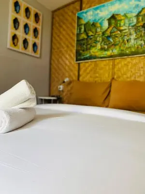 a close up of a bed with towels on it at Kampoeng Saya in Seminyak