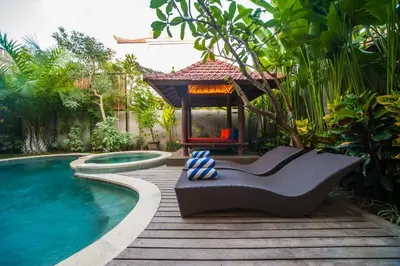 a backyard with a pool and a gazebo at Villa Suzuki 2 Seminyak in Seminyak