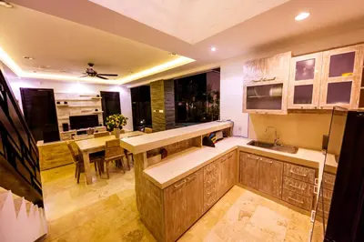 a kitchen with a table and a dining room at Villa Suzuki 3 Seminyak in Seminyak