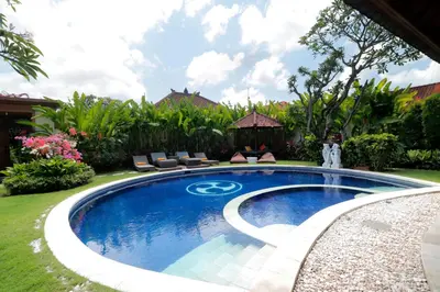 a swimming pool in the yard of a house at Heliconia Villa in Seminyak