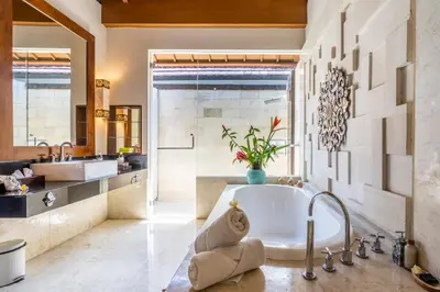 a bathroom with a tub and a sink at The Akasha Seminyak Bali Luxury Villas in Seminyak