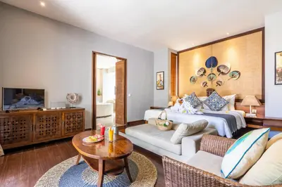 a living room with a bed and a couch at The Akasha Seminyak Bali Luxury Villas in Seminyak