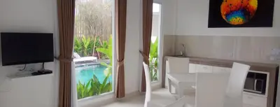 a kitchen with a large window and a dining table at The Bali Bubble in Sanur