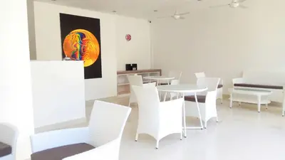 a dining room with white chairs and a table at The Bali Bubble in Sanur