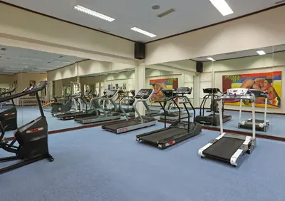 a gym with a bunch of treadmills and ellipticals at Bintang Bali Resort in Kuta