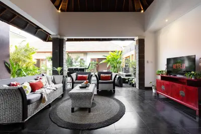 a living room with couches and a flat screen tv at Villa Lapiz Lazuli Seminyak Kuta in Seminyak