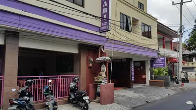 two motorcycles parked in front of a building at Guest House Matahari in Kuta