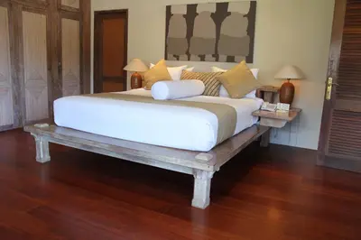 a bedroom with a large bed on a wooden table at Sienna Villas Seminyak in Seminyak