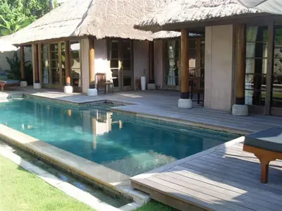 a resort with a swimming pool and a building at Sienna Villas Seminyak in Seminyak