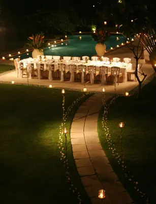 an outdoor wedding with tables and lights at night at Sienna Villas Seminyak in Seminyak