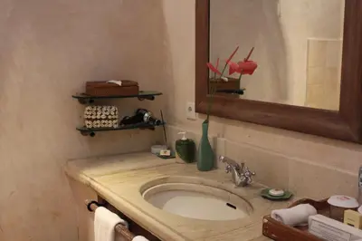 a bathroom with a sink and a mirror at Sienna Villas Seminyak in Seminyak
