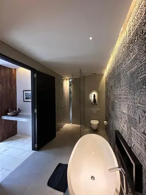 a bathroom with a white tub and a sink at Villa 80361 in Seminyak