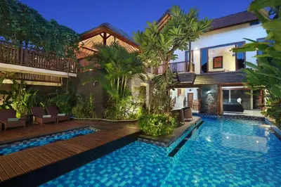 a swimming pool in front of a villa at Villa Blue in Seminyak
