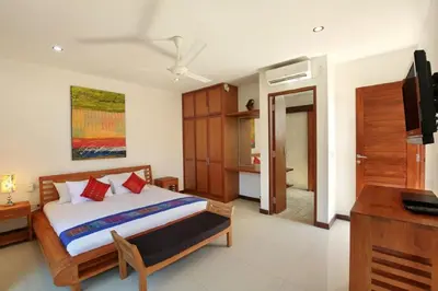 a bedroom with a bed and a television in a room at Villa Blue in Seminyak