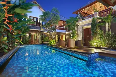 a swimming pool in front of a villa at Villa Blue in Seminyak