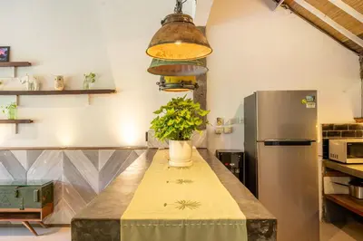 a kitchen with a table with a vase of flowers on it at Villa Sarong 1 in Seminyak