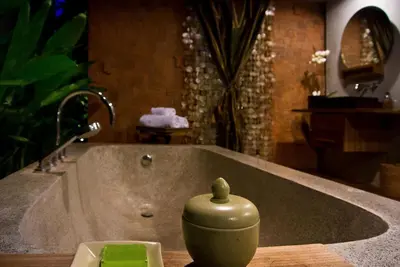a bathroom sink with a vase sitting on a counter at Komea Villa in Canggu