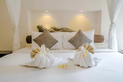 two towel animals are sitting on a bed at Villa Seminyak William in Seminyak