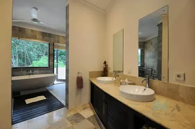 a bathroom with two sinks and a large mirror at Villa Seminyak William in Seminyak