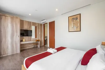a bedroom with a large bed and a television at Cove Villa Prana in Jimbaran