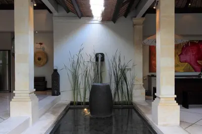a lobby with a water fountain in the middle at Villa Maju in Seminyak