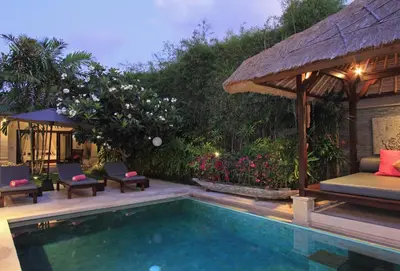 a swimming pool in a villa with a resort at Villa Maju in Seminyak