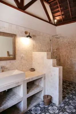 a bathroom with a sink and a shower at Villa Hangat in Seminyak