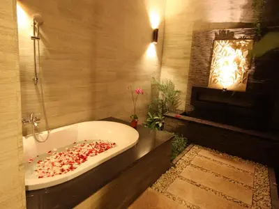 a bathroom with a bath tub filled with seeds at Grania Bali Villas in Seminyak