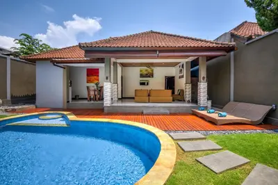 a swimming pool in the yard of a house at Gracia Bali Villas & Apartment Managed by Manara in Seminyak