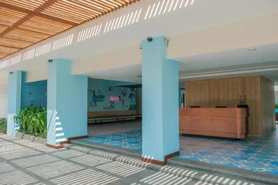 a lobby with blue columns in a building at Bloo Bali Hotel in Legian
