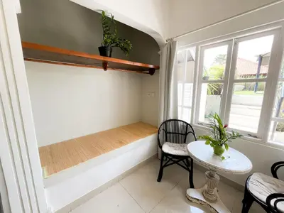 a small room with a bench and a table at Casa Artista By Kresna Hospitality in Seminyak
