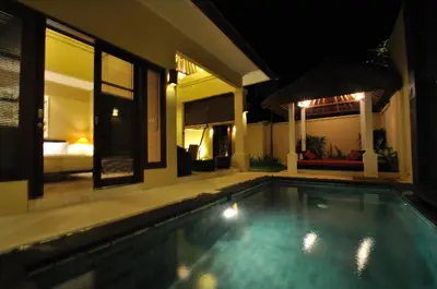 a swimming pool in a house at night at The Jas Villas in Seminyak