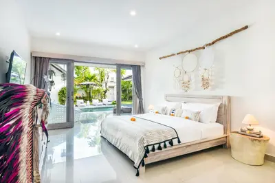 a bedroom with a bed and a pool at Villa Maviba in Seminyak