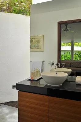 a bathroom with a sink and a mirror on a counter at Villa La Sirena by Nagisa Bali in Seminyak