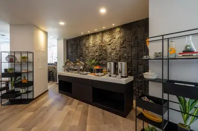 a kitchen with a counter with food in it at Everyday Hotel Kuta Central in Kuta