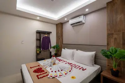 a hotel room with a bed with a cake on it at Everyday Hotel Kuta Central in Kuta
